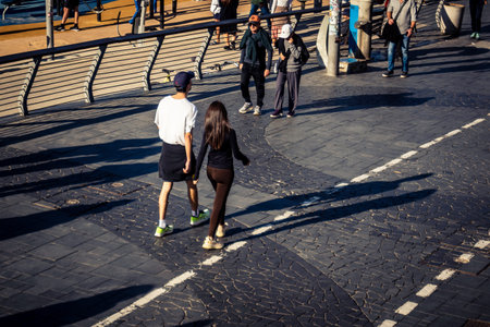 Tel Aviv, Israel, January 3, 2026 Passersby stroll along the Tel Aviv promenade facing the Mediterranean Sea, demonstrating daily resilience despite regional security tensions in the Middle East.のeditorial素材