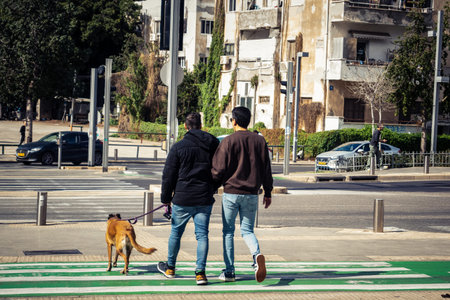 Tel Aviv, Israel, March 7, 2026 People walking through the busy urban streets of Tel Aviv, capturing...