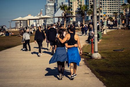 Tel Aviv, Israel, January 3, 2026 Passersby stroll along the Tel Aviv promenade facing the Mediterranean Sea, demonstrating daily resilience despite regional security tensions in the Middle East.のeditorial素材