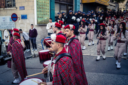 Bethlehem, West Bank, December 24, 2025 Palestinian scout marching band performs during the Christmas parade. Musicians dressed in traditional uniforms lead the procession through the historic streetsのeditorial素材