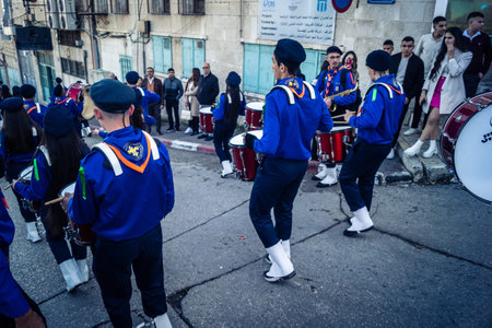 Bethlehem, West Bank, December 24, 2025 Palestinian scout marching band performs during the Christmas parade. Musicians dressed in traditional uniforms lead the procession through the historic streetsのeditorial素材