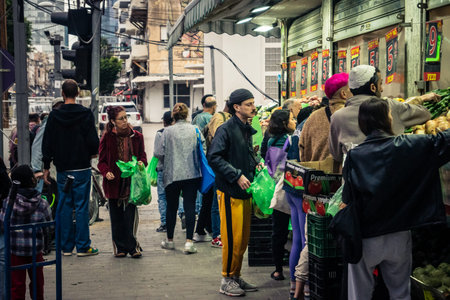 Tel Aviv, Israel, March 13, 2026 People shopping at Levinsky Market, daily life scene with customers and vendors in traditional Mediterranean market.のeditorial素材