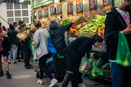 Tel Aviv, Israel, March 13, 2026 People shopping at Levinsky Market, daily life scene with customers and vendors in traditional Mediterranean market.のeditorial素材