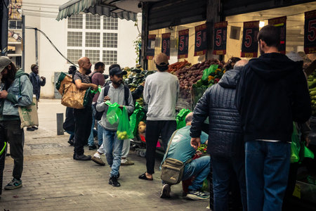 Tel Aviv, Israel, March 13, 2026 People shopping at Levinsky Market, daily life scene with customers and vendors in traditional Mediterranean market.のeditorial素材
