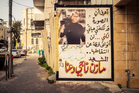 Hebron, West Bank, January 30, 2026 Arabic language posters, political signs and torn advertisements on urban walls in the city center of Hebron.のeditorial素材