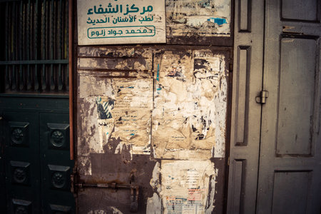 Hebron, West Bank, January 30, 2026 Arabic language posters, political signs and torn advertisements on urban walls in the city center of Hebron.のeditorial素材
