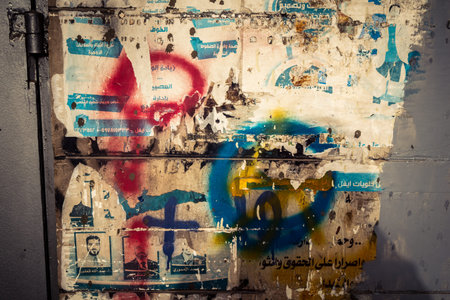 Hebron, West Bank, January 30, 2026 Arabic language posters, political signs and torn advertisements on urban walls in the city center of Hebron.のeditorial素材