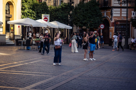Seville, Spain, September 21, 2025 Tourists visit the historic district of downtown Seville and walk through the narrow, picturesque streets.のeditorial素材