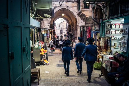 Jerusalem, Israel, December 13, 2025 Busy alleyways and atmospheric plays of light in the Christian Quarter souk of Jerusalem providing a glimpse of the variety of items displayed by local vendors.のeditorial素材