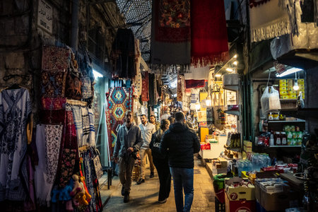 Jerusalem, Israel, December 13, 2025 Busy alleyways and atmospheric plays of light in the Christian Quarter souk of Jerusalem providing a glimpse of the variety of items displayed by local vendors.のeditorial素材