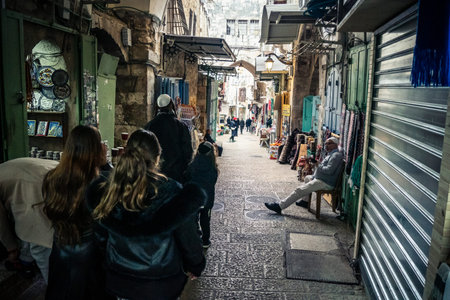 Jerusalem, Israel, December 13, 2025 Busy alleyways and atmospheric plays of light in the Christian Quarter souk of Jerusalem providing a glimpse of the variety of items displayed by local vendors.のeditorial素材