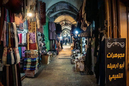 Jerusalem, Israel, December 13, 2025 Busy alleyways and atmospheric plays of light in the Christian Quarter souk of Jerusalem providing a glimpse of the variety of items displayed by local vendors.のeditorial素材