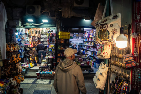Jerusalem, Israel, December 13, 2025 Busy alleyways and atmospheric plays of light in the Christian Quarter souk of Jerusalem providing a glimpse of the variety of items displayed by local vendors.のeditorial素材