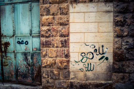 Hebron, West Bank, Palestine, March 28, 2026 Palestinian political graffiti, including Free Palestine, Gaza, and 1948 references, are seen on shop shutters in the H2 sector of Hebron's old city. Many of these commercial units have been forcibly closed by のeditorial素材