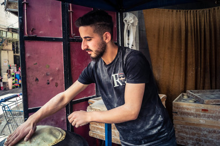 Hebron, West Bank, Palestine, March 31, 2026 A Palestinian artisan is seen skillfully preparing...