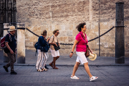 Seville, Spain, September 21, 2025 Tourists visit the historic district of downtown Seville and walk...