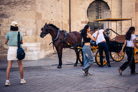 Seville, Spain, September 21, 2025 Tourists visit the historic district of downtown Seville and walk...