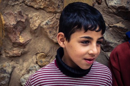 Hebron, West Bank, Palestine, April 01, 2026 Two young Palestinian boys are walking along a narrow, ancient stone alleyway within the heart of the historic Old City of Hebron. The children, wearing everyday hoodies, navigate the complex, labyrinthine streのeditorial素材