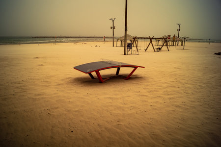 Tel Aviv, Israel, March 14, 2026 Empty playgrounds and beach structures stand abandoned as a thick...