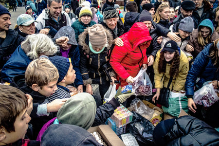 Kherson, Ukraine, November 20, 2022 Residents  receive food supplies in Freedom Square. The tension...