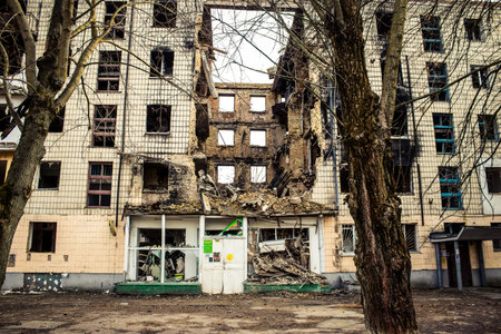 Borodyanka, Ukraine - March 14, 2023 Facade of a building having received artillery fire. Most...