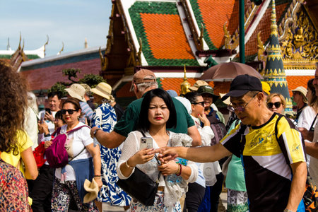 Bangkok, Thailand, December 12, 2024 Tourists visiting The Grand Palace, a complex of buildings at the heart of Bangkok. The palace has been the official residence of the Kings of Siam since 1782.のeditorial素材
