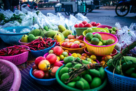 Bangkok, Thailand, March 12, 2025. A street vegetable market in Bangkok. Fresh markets are sprawling and chaotic, brimming with fresh produce in large quantities and at very low prices.のeditorial素材
