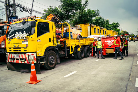 Bangkok, Thailand, March 31, 2025 Construction vehicles are being used at the site of a building...