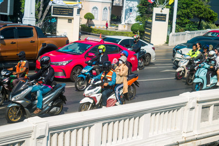 Bangkok, Thailand, March 06, 2025 People rolling with a motorcycle in the streets of Bangkok,...