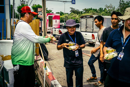 Bangkok, Thailand, April 02, 2025 Volunteers set up tents and distribute water and food to rescuers...
