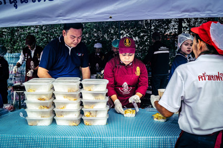 Bangkok, Thailand, April 02, 2025 Volunteers set up tents and distribute water and food to rescuers...