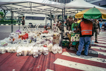 Bangkok, Thailand, March 29, 2025. Volunteers set up tents and distribute water and food to rescuers...