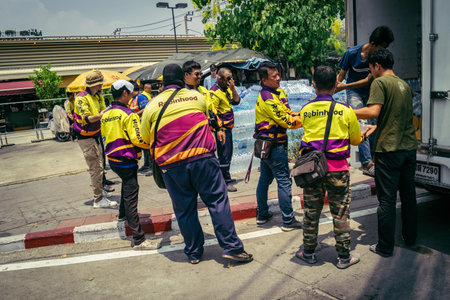 Bangkok, Thailand, March 29, 2025 Volunteers carry water bottles for rescuers at the site of a...