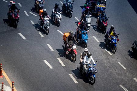 Bangkok, Thailand, March 06, 2025 People rolling with a motorcycle in the streets of Bangkok,...