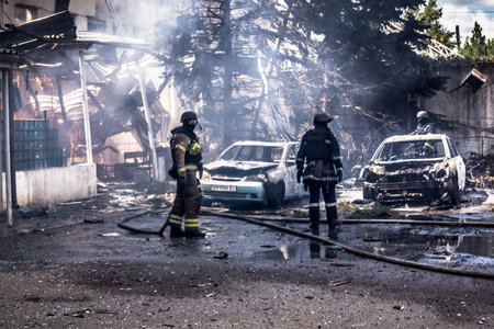 Kharkiv, Ukraine, July 24, 2025 Firefighters respond to an attack on Kharkiv city center, which was hit by two Russian KABs. Buildings and cars are on fire, and many windows are destroyed.