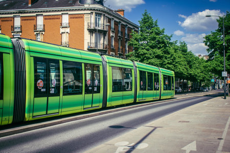 Reims, France, May 15, 2025 A modern electric tram runs through the streets of Reims, an iconic city of Champagne in France. This is a fast and economical way to get around the city.