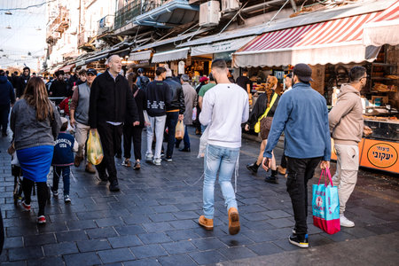 Jerusalem, Israel - December 22, 2023 People shopping at Mahane Yehuda Market, often referred to as "The Shuk", is a marketplace in Jerusalem. Popular with locals and tourists alike