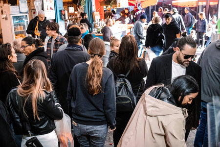 Jerusalem, Israel - December 22, 2023 People shopping at Mahane Yehuda Market, often referred to as "The Shuk", is a marketplace in Jerusalem. Popular with locals and tourists alike