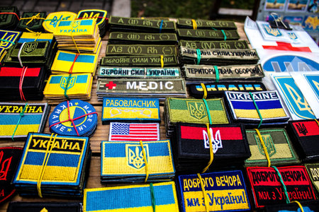 Decorative objects sold on the streets of kyiv in Ukraine, unit patches and other wartime memorabilia revolve around the military spirit and are bought by people as souvenirs on the current war against Russia. The vendors, who have sold  trinkets on their