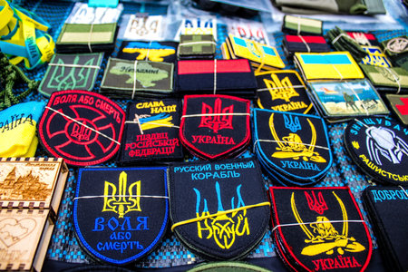 Decorative objects sold on the streets of kyiv in Ukraine, unit patches and other wartime memorabilia revolve around the military spirit and are bought by people as souvenirs on the current war against Russia. The vendors, who have sold  trinkets on their