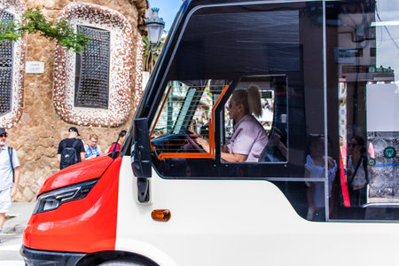 Barcelona, Spain - August 28, 2023 Bus driving in the streets of Barcelona and part of the transport system of the city, the fares are not expensive.