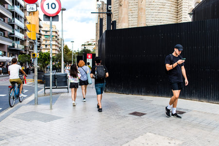 Barcelona, Spain - August 28, 2023 Tourists walking in the street of Barcelona, an emblematic city and the capital of Catalogne in Spain.