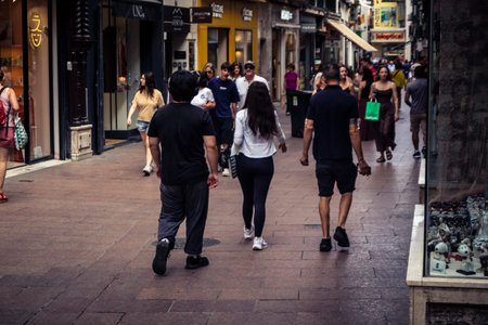 Seville, Andalusia, Spain. July 22, 2026. Shoppers and holidaymakers browse storefronts and local merchandise along Calle Sierpes in the heart of Seville's Casco Antiguo.