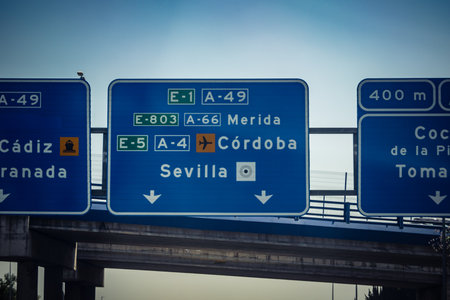 Carmona, Andalusia, Spain. July 28, 2026. Overhead directional gantry signs and electronic display panels line the A4 Autovia del Sur highway as vehicular traffic flows toward Seville. Large metal gantries span across active lanes, displaying real-time tr