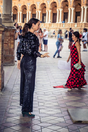 Seville, Andalusia, Spain, August 11, 2026. Flamenco dancers perform alongside a guitarist, singer, and hand clapper under the tiled alcoves of the Place of Spain in Seville. Street performers showcase traditional Andalusian art, music, and dance to gathe