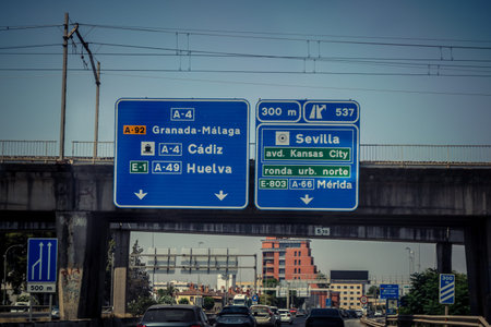 Carmona, Andalusia, Spain. July 28, 2026. Overhead directional gantry signs and electronic display panels line the A4 Autovia del Sur highway as vehicular traffic flows toward Seville. Large metal gantries span across active lanes, displaying real-time tr