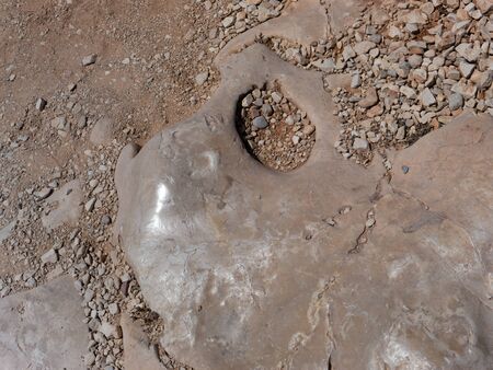 Floor with plenty of stones on it. There is a big, polished and shiny stone.の写真素材