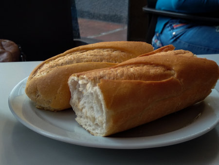 Two pieces of common bread on a plate