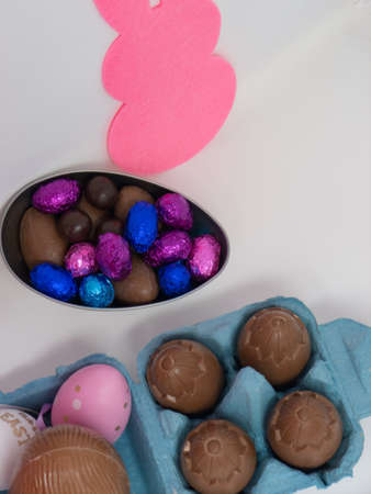 Chocolate Easter eggs in an egg carton and in an egg-shaped container