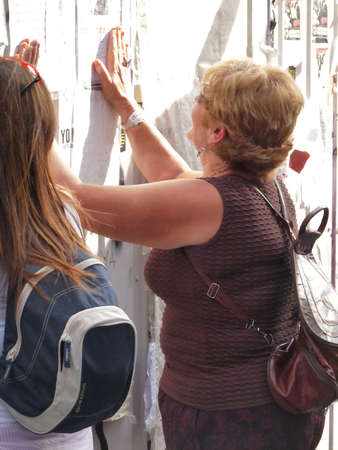 Madrid, Spain; June 11 2011. Elderly lady hitting a construction site barrier in protest. 15-M Outraged protests at Puerta del Sol in Madrid. Photography taken on June 11 2011 in Madrid, Spainのeditorial素材